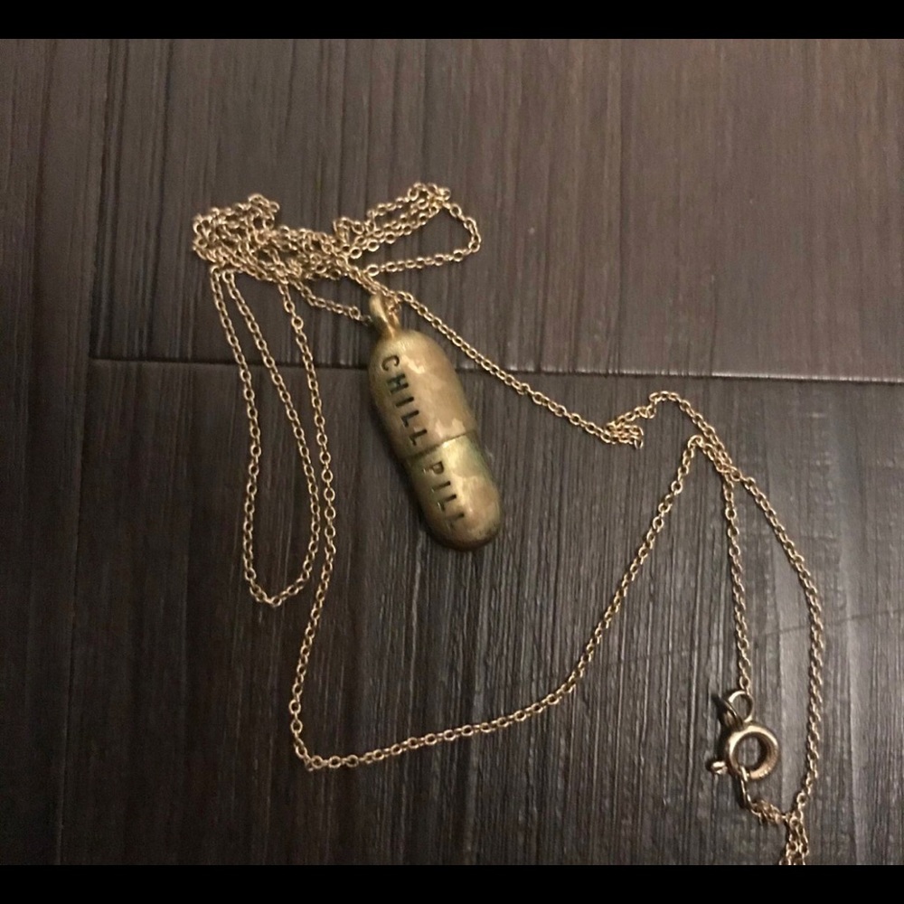 Vintage Chill pill pendant tarnished gold in color